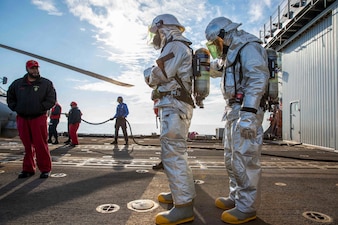 Sailors assigned to the Ticonderoga-class guided-missile cruiser USS Leyte Gulf (CG 55) prepare to rescue personnel during an aircraft firefighting drill, Dec. 22, 2022.