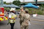 Battalion Chief Lisa Forrest, Philadelphia Fire Department, U.S. Army 2nd Lt. Laura Easterling, platoon leader, and Sgt. Nicole Phannis, a reconnaissance Soldier, both assigned to the 140th Chemical Company, California National Guard, discuss decontamination operations for a chemical spill training during the Dense Urban Terrain (DUT) exercise at the CSX Railyard in Philadelphia, Pa., July 27, 2022.