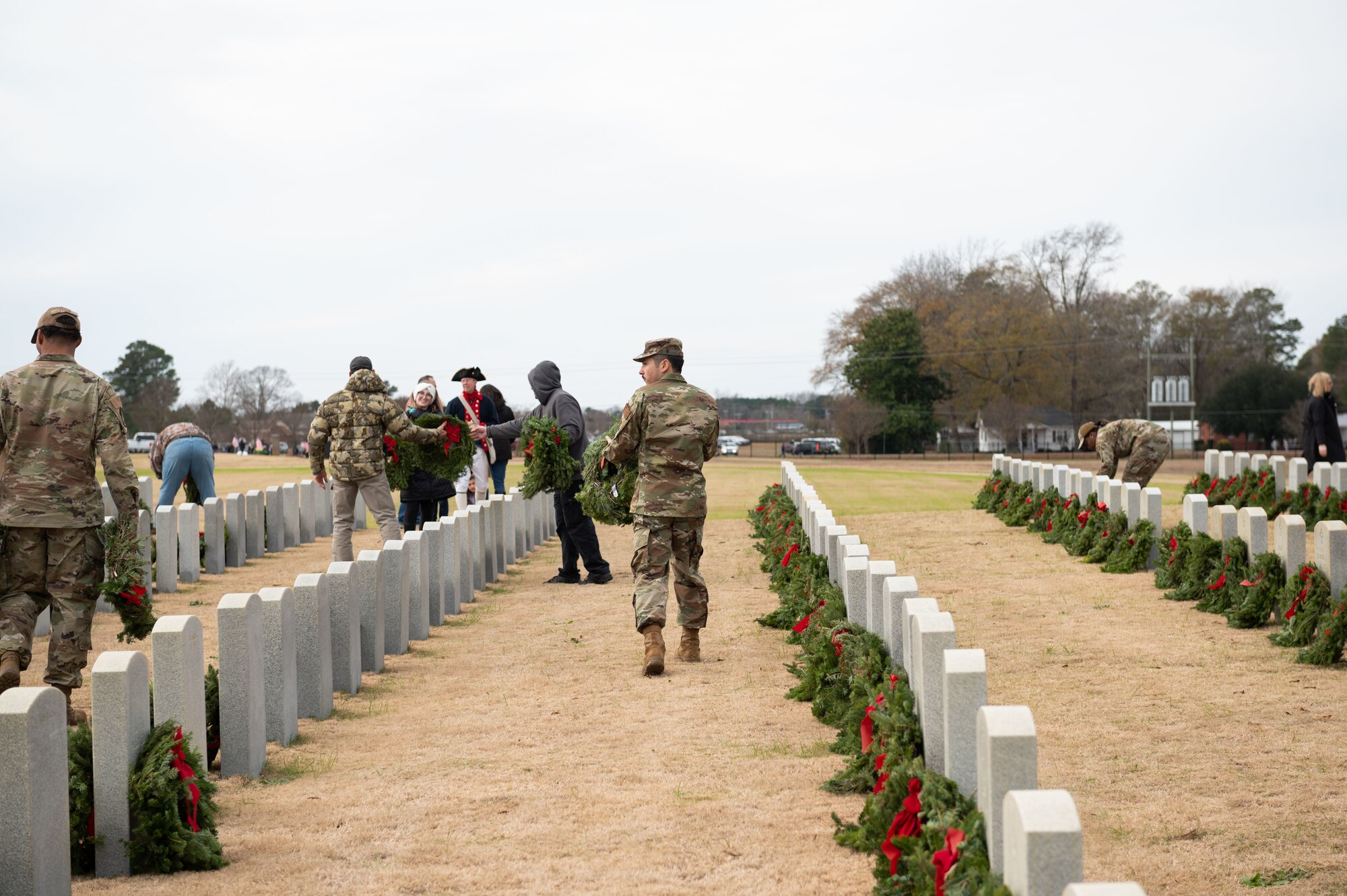 Airmen assigned to Seymour Johnson Air Force Base, North Carolina, and members of the community, lay wreaths during Wreaths Across America at Eastern Carolina Veterans Cemetery, Goldsboro, N.C., Dec. 17, 2022. Wreaths Across America is conducted each December at more than 3,400 locations in all 50 states and throughout the world, with the intent of raising awareness and appreciation for the sacrifices of veterans.  (U.S. Air Force photo by Airman 1st Class Rebecca Sirimarco-Lang)