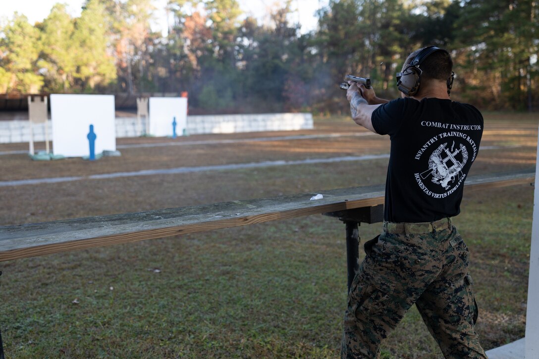 U.S. Marine Corps Sgt. Jack Fontaine, a combat instructor with Infantry Training Battalion, School of Infantry-East, fires his M18 pistol during the pistol team relay portion of the Intramural Marksmanship Competition on Stone Bay, Marine Corps Base Camp Lejeune, North Carolina, Dec. 7, 2022. The Marine Corps Intramural Marksmanship Competition inspires unit cohesion and mission readiness by allowing Marines to compete and improve lethality with both rifle and pistol weapons. (U.S. Marine Corps photo by Cpl. Antonino Mazzamuto)