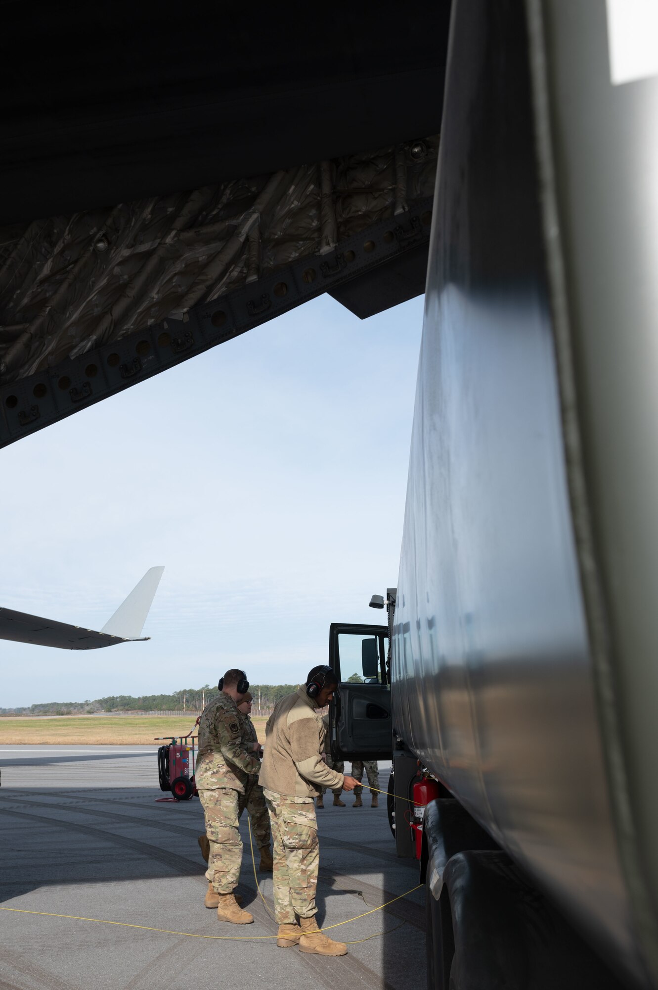 Members of the 4th Fighter Wing, from Seymour Johnson Air Force Base North Carolina, prepare to refuel a C-17 Globemaster III at Marine Corps Air Station Cherry Point, N.C., Dec. 14, 2022. An integrated combat turn exercise is the use of military personnel and equipment to rapidly refuel and rearm aircraft. (U.S. Air Force photo by Airman 1st Class Rebecca Sirimarco-Lang)