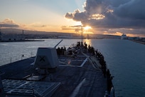 (Dec. 29, 2022) Sailors assigned to the Arleigh Burke-class guided-missile destroyer USS Nitze (DDG 94) man the rails as the ship arrives in Civitavecchia, Italy for a scheduled port visit, Dec. 29, 2022. The George H.W. Bush Carrier Strike Group is on a scheduled deployment in the U.S. Naval Forces Europe area of operations, employed by U.S. Sixth Fleet to defend U.S., allied, and partner interests.