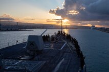 (Dec. 29, 2022) Sailors assigned to the Arleigh Burke-class guided-missile destroyer USS Nitze (DDG 94) man the rails as the ship arrives in Civitavecchia, Italy for a scheduled port visit, Dec. 29, 2022. The George H.W. Bush Carrier Strike Group is on a scheduled deployment in the U.S. Naval Forces Europe area of operations, employed by U.S. Sixth Fleet to defend U.S., allied, and partner interests.