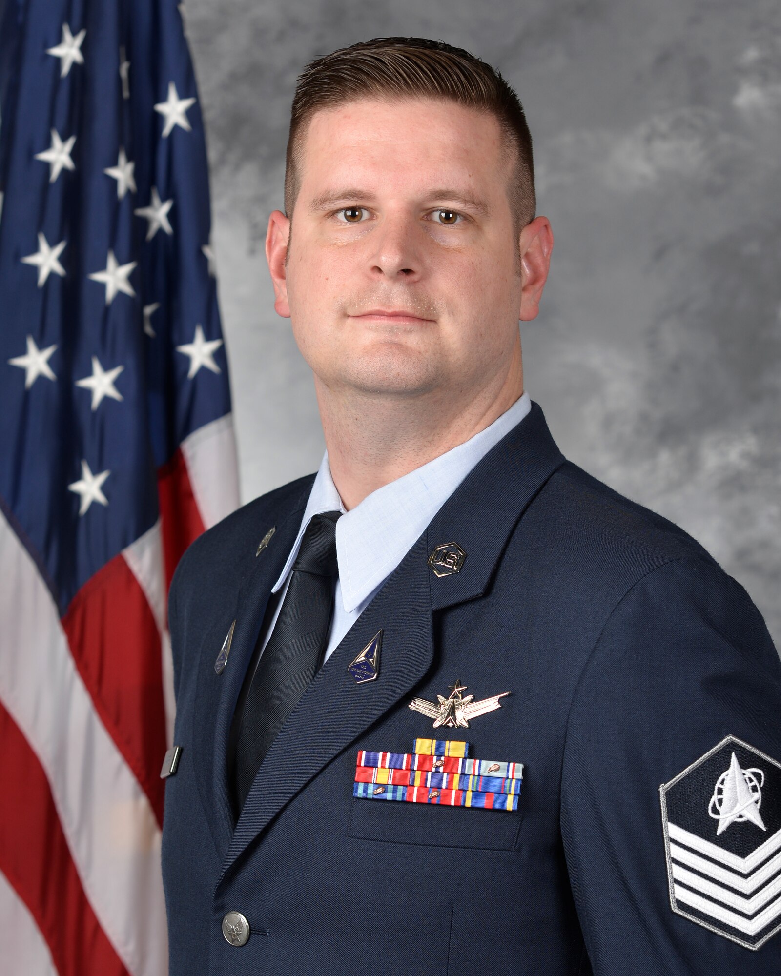 A man poses for an official photo