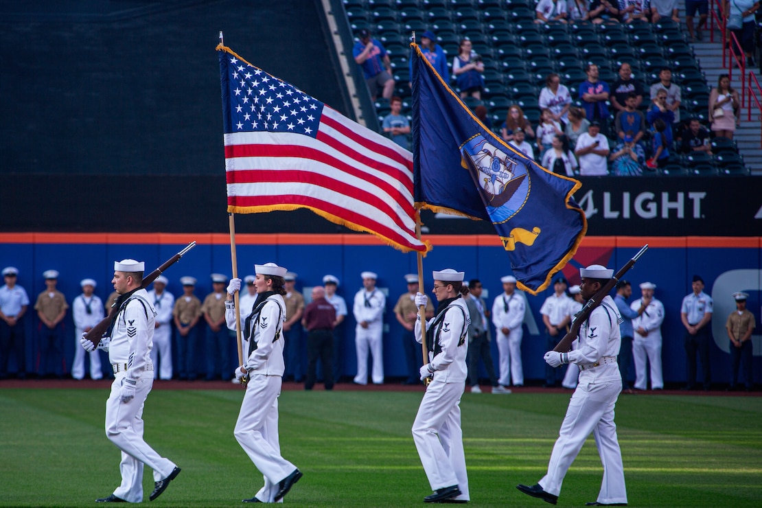U.S. Navy color guard march into place for the national anthem at a professional baseball game in Queens, New York on May 30, 2022. As a part of Fleet Week New York 22, the Marines of Special Purpose Marine-Air Ground Task Force New York engage in special events throughout New York City and the tristate area showcasing sea service technologies, future innovation, and connecting with citizens. Fleet Week New York brings together more than 2,000 service members from the Marine Corps, Navy and Coast Guard offering live band performances, military vehicle and equipment displays, and other community relations projects.