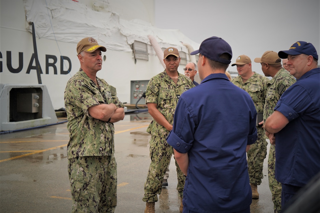 Rear Admiral Scott Gray, Commander, Navy Region Mid-Atlantic, speaks with representatives from National Oceanic and Atmospheric Administration (NOAA), United States Coast Guard and the installation port operations team during his visit to Pier 2 at Naval Station Newport. The visit is the first trip to Newport for the region commander since taking charge of NRMA in late July.