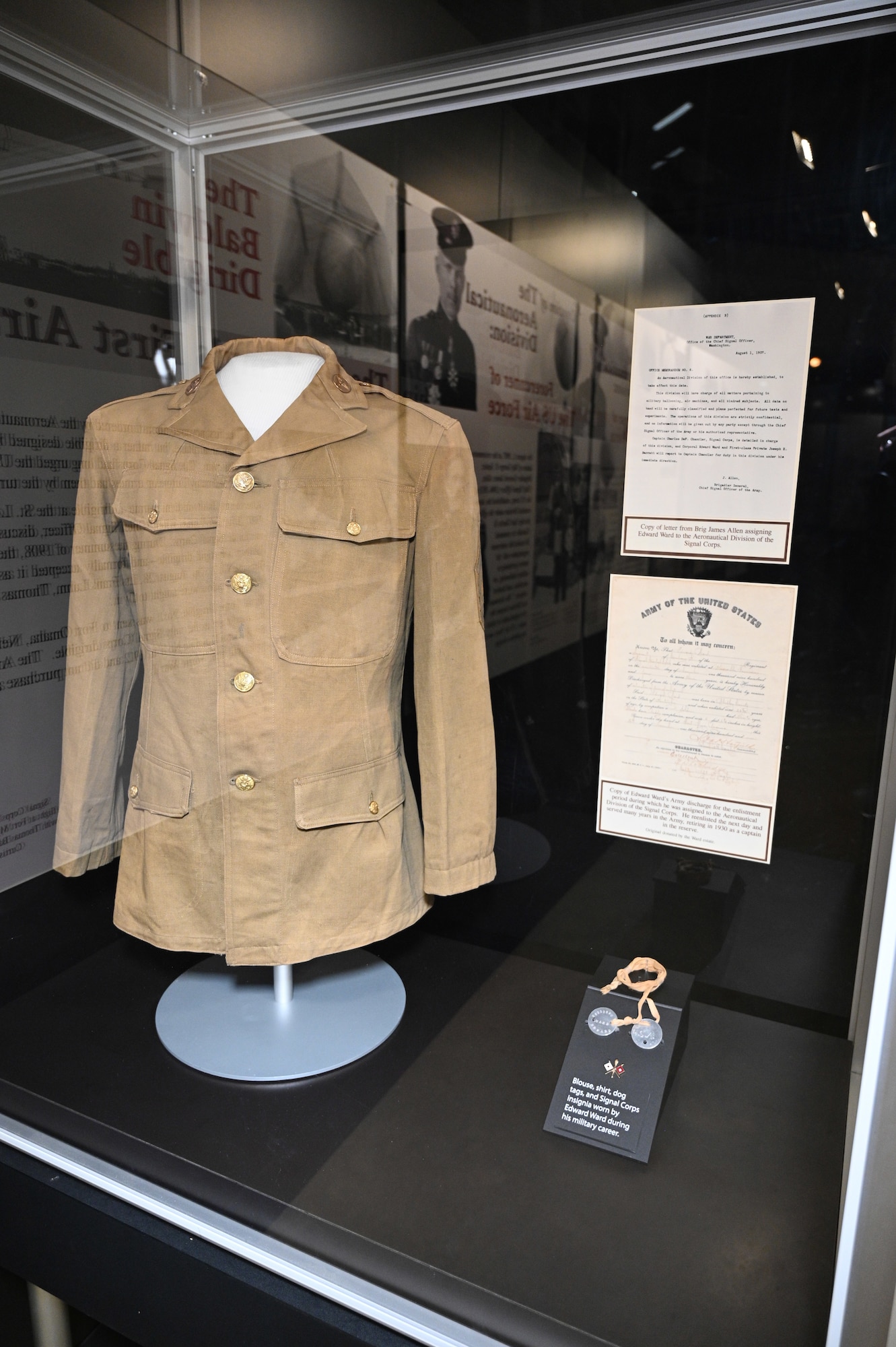 Blouse, shirt, dog tags, and Signal Corps insignia worn by Edward Ward during his military career.