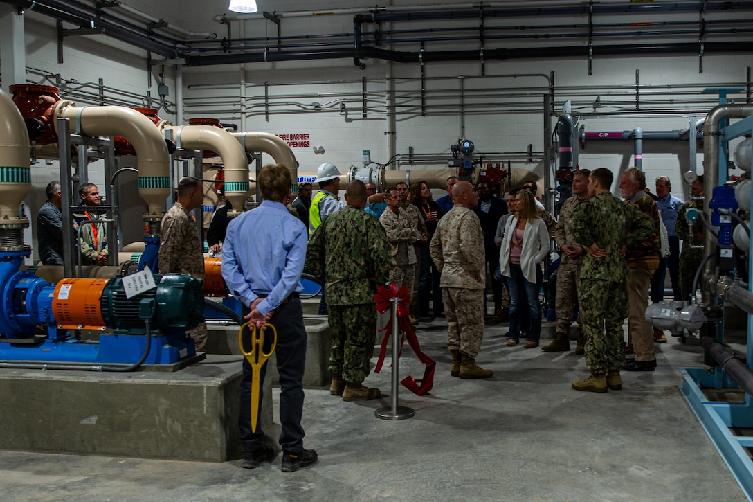 David Massie, lead water treatment plant operator with military construction contractor CDM Smith, gives a tour of the facility during the water treatment facility ribbon cutting ceremony at Marine Corps Air Ground Combat Center (MCAGCC), Twentynine Palms, California, Nov. 08, 2022. The water treatment facility was built by NAVFAC SW, MCAGCC Public Works Division, and a military construction contractor to give base personnel a new, independent source of clean water. (U.S. Marine Corps photo by Cpl. Jonathan Willcox)