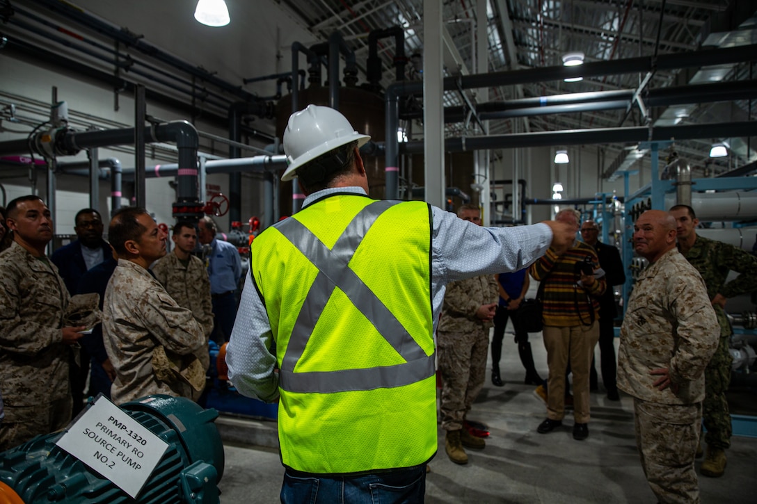 David Massie, lead water treatment plant operator with military construction contractor CDM Smith, gives a tour of the facility during the water treatment facility ribbon cutting ceremony at Marine Corps Air Ground Combat Center (MCAGCC), Twentynine Palms, California, Nov. 08, 2022. The  water treatment facility built by NAVFAC SW, MCAGCC Public Works Division, and military construction contractor CDM Smith to give base personnel a new, independent source of clean water. (U.S. Marine Corps photo by Cpl. Jonathan Willcox)