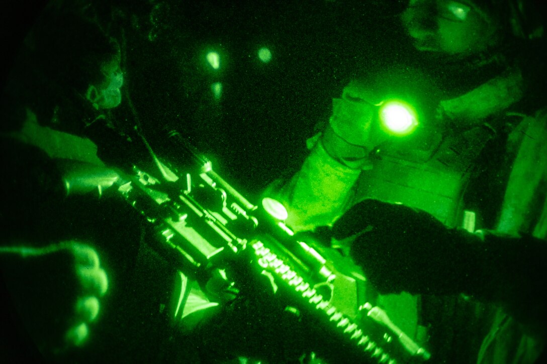U.S. Marines with 3rd Battalion, 7th Marine Regiment inspect their weapons before a live-fire night range at Marine Corps Air Ground Combat Center, Twentynine Palms, California, Dec. 12, 2022. Marines maintain lethality by training during day and night to increase preparedness for any situation. (U.S. Marine Corps photo by Cpl. Jonathan Willcox)
