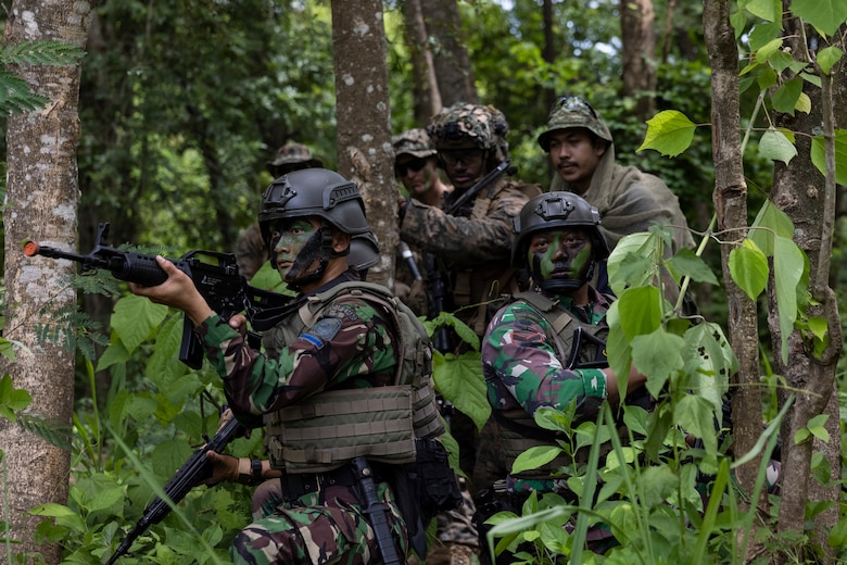 Indonesia (Dec. 14, 2022) - U.S. Marines with Battalion Landing Team 2/4, 13th Marine Expeditionary Unit, observe how Indonesian Marines maneuver through the jungle during Cooperation Afloat Readiness and Training (CARAT)/Marine Exercise (MAREX) Indonesia 2022, Dec. 14. CARAT/MAREX Indonesia is a bilateral exercise between Indonesia and the United States designed to promote regional security cooperation, maintain and strengthen maritime partnerships, and enhance maritime interoperability. In its 28th year, the CARAT series is comprised of multinational exercises, designed to enhance U.S. and partner navies’ and marine corps abilities to operate together in response to traditional and non-traditional maritime security challenges in the Indo-Pacific region. (U.S. Marine Corps photo by Sgt. Nicolas Atehortua)