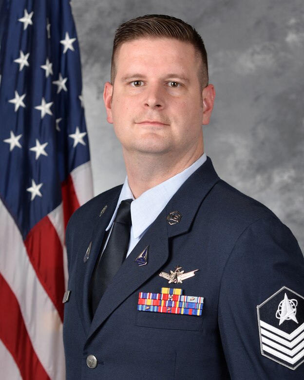 A man poses for an official photo