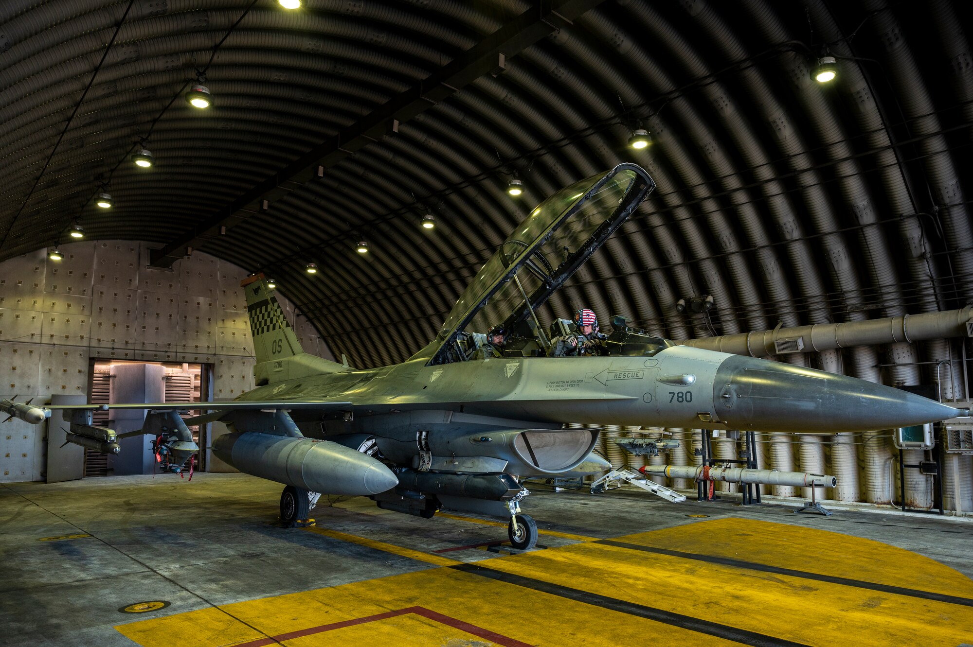 U.S. Air Force Capt.’s Trevor Schmidt and Boston Nimmer, 36th Fighter Squadron (FS) pilots perform pre-flight checks on an F-16 Fighting Falcon before a training mission at Osan Air Base, Republic of Korea, Dec. 28, 2022.