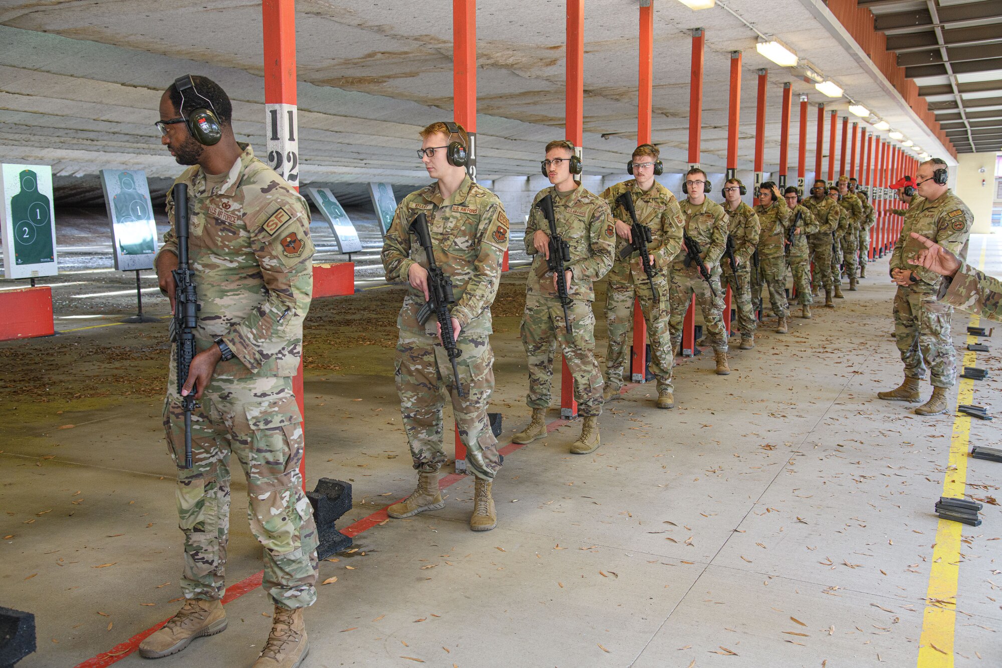 Airmen prepare to practice their weapons training at Maxwell Air Force Base, December 6, 2022. The Airmen gathered in a field training area where, after being given a specific scenario, they operated as a team, responded to threats, and accomplished the mission.