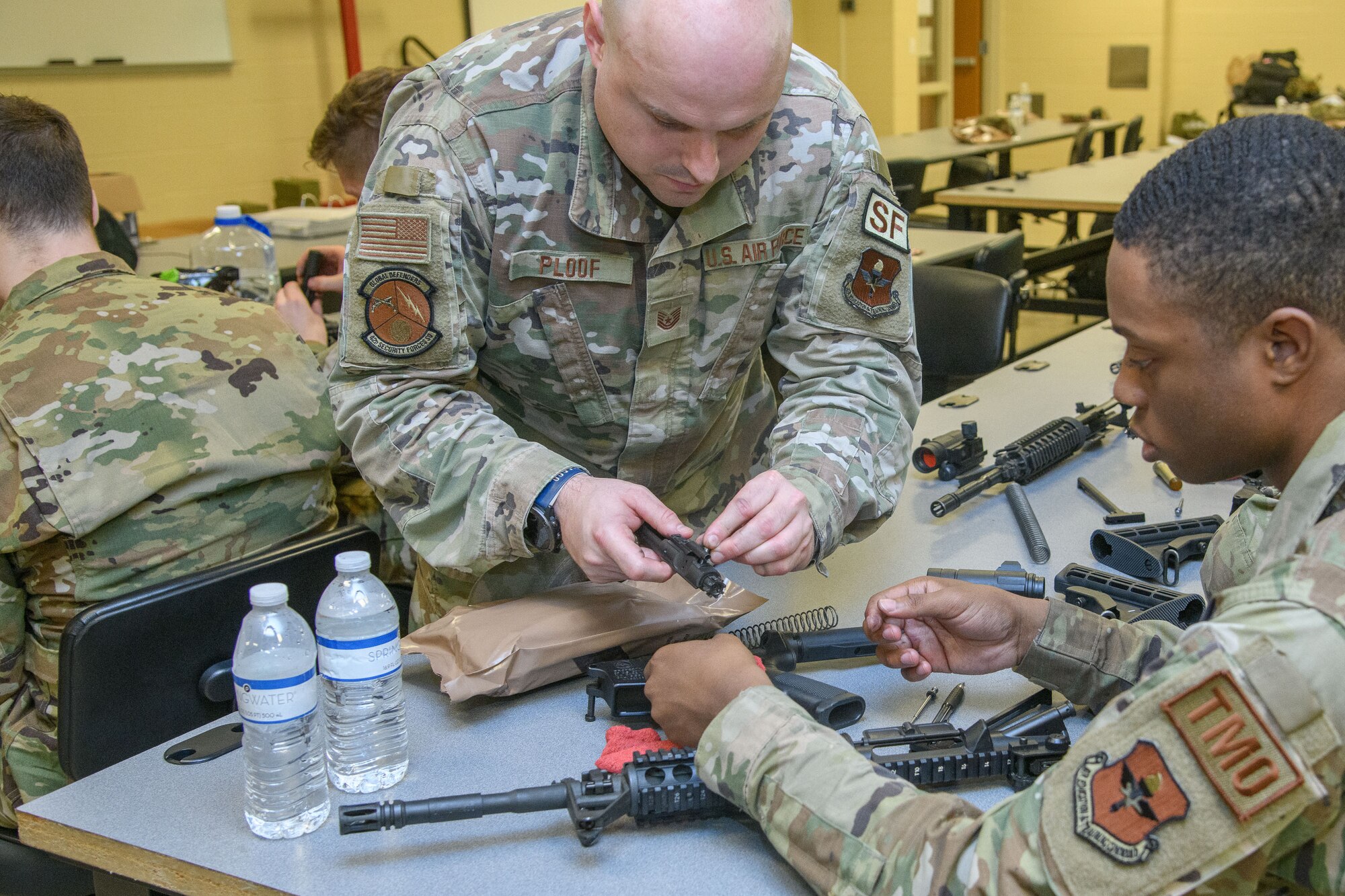 Tech. Sgt. Brian Ploof, shows an airman how to reconstruct a weapon at Maxwell Air Force Base, December 6, 2022. The 42nd Mission Support Group hosted a Readiness Reset Exercise in which a small team of Airmen from across the base participated in rigorous combat scenarios in a three day event.