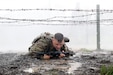 Spc. Patrick Kusik, an indirect fire infantryman assigned to 1st Battalion, 111th Infantry Regiment, 56th Stryker Brigade Combat Team, 28th Infantry Division, Pennsylvania Army National Guard low crawls under barbed wire while navigating an individual movement technique lane April 23 at Fort Indiantown Gap, Pa. Kusik attended a four-day Ranger Sapper Assessment Program and the IMT lane was an evaluated event. This event was designed to prepare the trainees for the infamous Malvesti obstacle course, a wet and muddy confidence course that they will encounter if selected to attend Ranger School. (U.S. Army National Guard photo by Staff Sgt. Shane Smith)