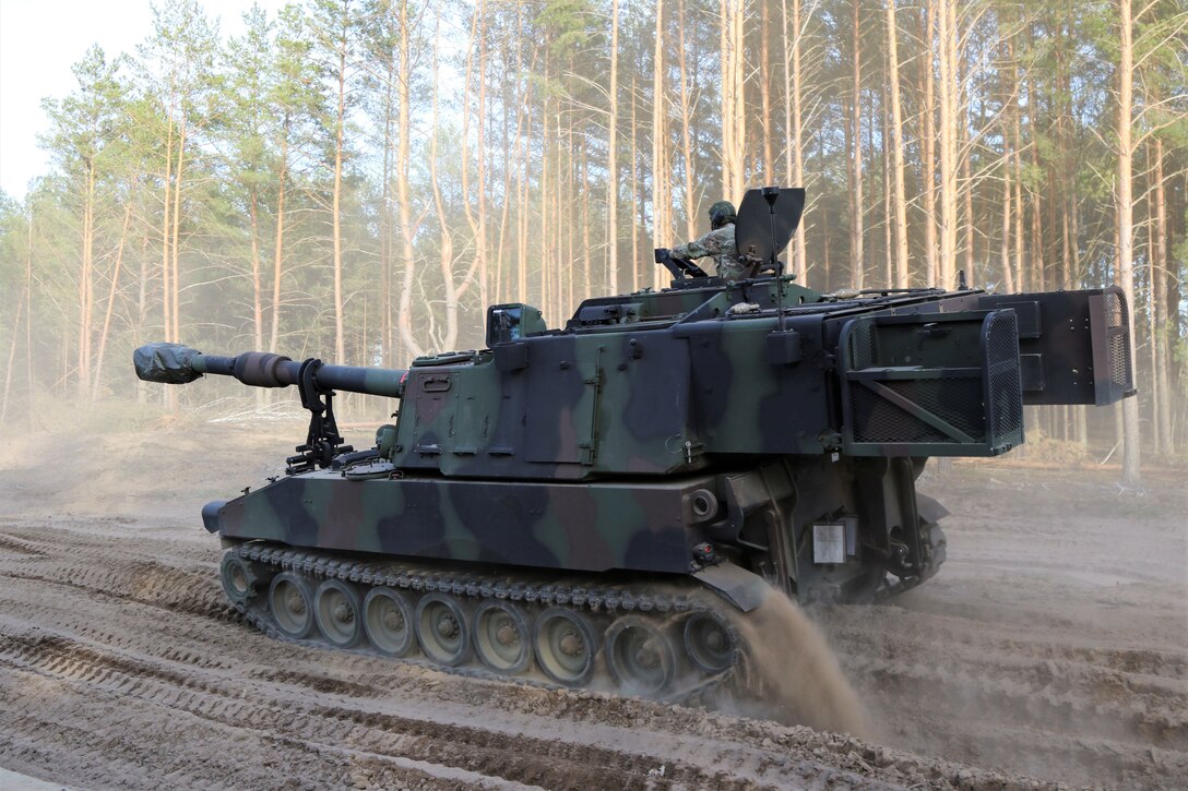 Soldiers with the 1st Battalion, 109th Field Artillery Regiment, 55th Maneuver Enhancement Brigade, 28th Infantry Division, Pennsylvania Army National Guard, drive M109A6 Paladins, M992A2 Field Artillery Ammunition Supply Vehicles, and M572 Armored Mortar Carriers from the Army Prepositioned Stock (APS) area to their cantonment area May 10, in Pabrade, Lithuania. The Soldiers are deployed to Lithuania in support of Defender Europe 22 and NATO exercise Flaming Thunder. (U.S. Army National Guard photo by Staff Sgt. Zane Craig)