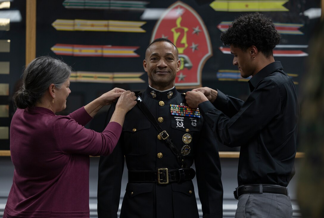 U.S. Marine Corps Maj. Gen. Calvert Worth Jr., 2d Marine Division commanding general, is pinned by his wife and son during his promotion ceremony on Camp Lejeune, North Carolina, Dec. 21, 2022. Since he took command of the division in August, Worth has taken an active approach to his principles of mindset, mission, and Marines. (U.S. Marine Corps photo by Cpl. Megan Ozaki)