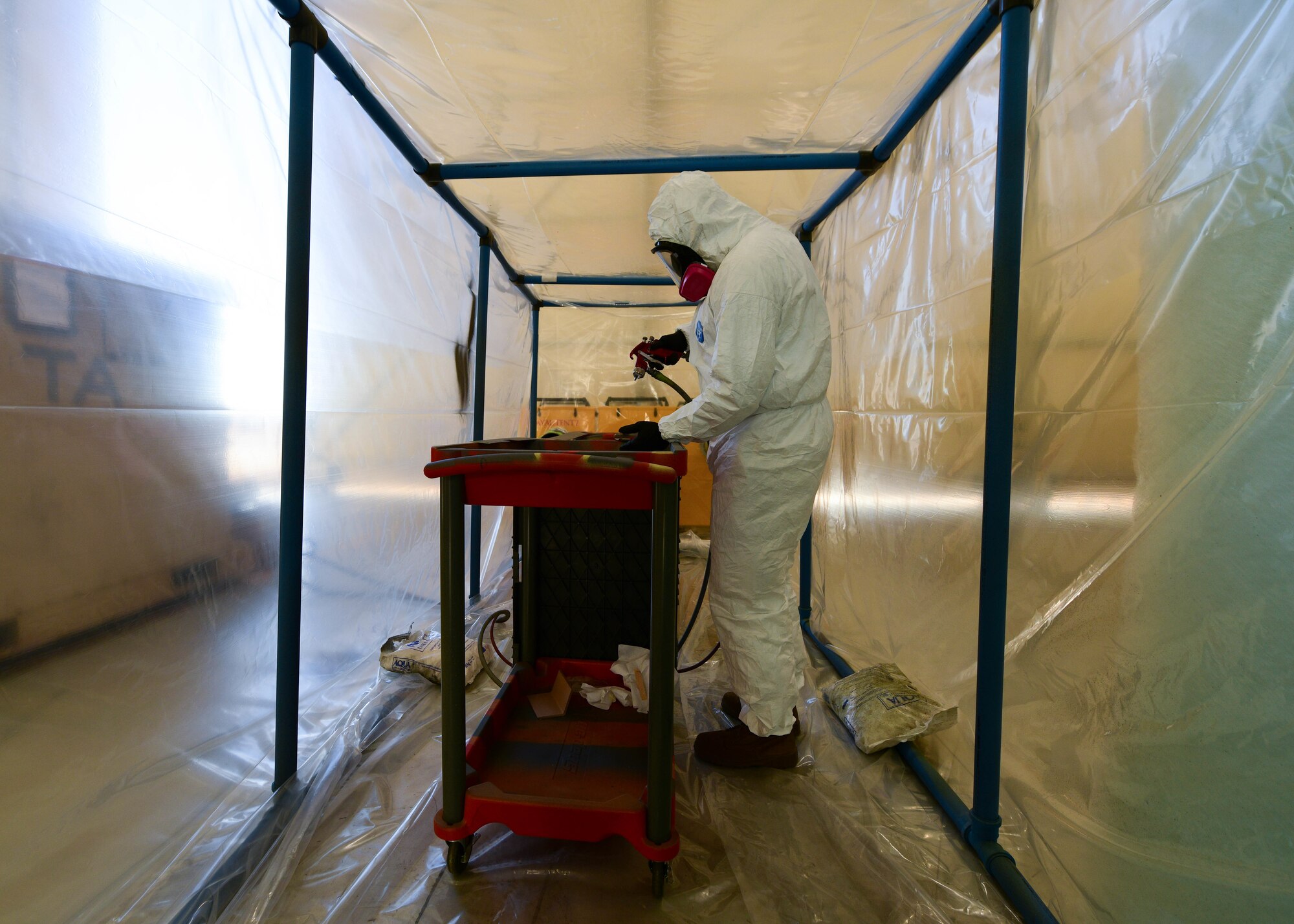 U.S. Staff Sgt. Cameron Keeney, 31st Maintenance Squadron aircraft structural maintenance craftsman, sprays paint on a leading edge fairing panel in the Tent N Vent at Aviano Air Base, Italy, Dec. 16, 2021. Due to some aircraft panels being bigger than the required minimum, the AMS Airmen had to spray the part, which then caused the Tent N Vent to be built. (U.S. Air Force photo by Senior Airman Brooke Moeder)