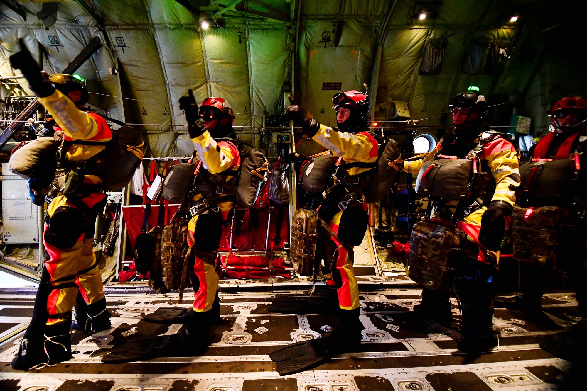 Pararescuemen assigned to the 57th Rescue Squadron prepare for drop over the Adriatic Sea outside Aviano Air Base, Italy, Jan. 13, 2021. The mission of the 57th RQS is personnel recovery, combat search and rescue. The Airmen perform various trainings to ensure they can accomplish their mission sets. (U.S. Air Force photo by Senior Airman Noah Sudolcan)