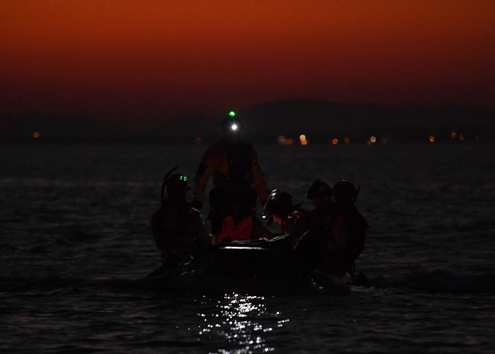 Pararescuemen assigned to the 57th Rescue Squadron finish putting together a Rigged Alternate Method Boat in the Adriatic Sea near Aviano Air Base, Italy, Jan. 13, 2021. A RAMB was dropped from the aircraft prior to the Pararescuemen performing static line jumps into the water. (U.S. Air Force photo by Senior Airman Brooke Moeder)