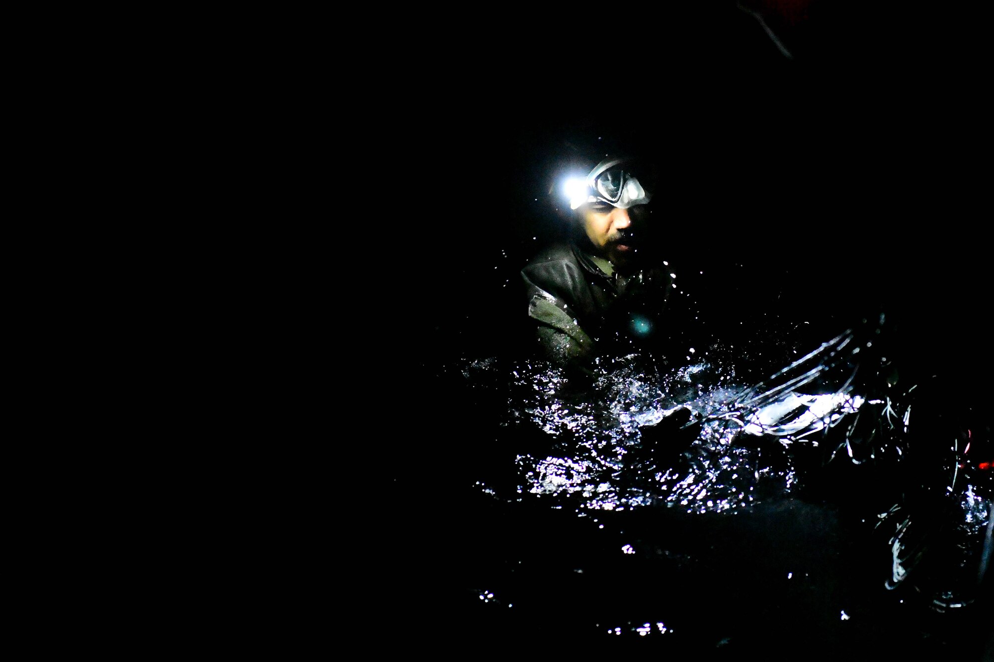 An Airman assigned to the 57th Rescue Squadron awaits recovery after parachuting into the Adriatic Sea outside Aviano Air Base, Italy, Jan. 12, 2021. The 57th RQS performs training weekly to ensure the mission of personnel recovery, combat search and rescue can be accomplished at the highest level. (U.S. Air Force photo by Senior Airman Noah Sudolcan)