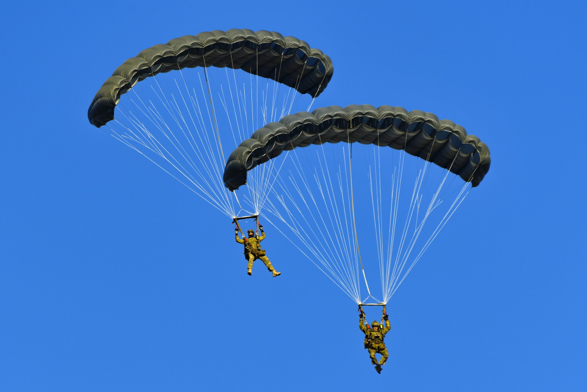 U.S. Air Force Pararescuemen from the 57th Rescue Squadron perform static line jumps over Aviano Air Base, Italy, Jan. 12, 2022. The mission of the 57th RQS is personnel recovery, combat search and rescue. The Airmen perform various trainings to ensure they can accomplish their mission sets. (U.S. Air Force photo by Senior Airman Thomas S. Keisler IV)