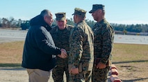 Secretary of the Navy Carlos Del Toro greets II Marine Expeditionary Force (II MEF) leaders, Lt. Gen. William Jurney, II MEF commanding general, Sgt. Maj. Lonnie Travis Jr., II MEF sergeant major, and Command Master Chief Christopher Rebana, II MEF command master chief, at Marine Corps Auxiliary Landing Field (MCALF) Bogue, North Carolina, Jan. 27, 2022. While at MCALF Bogue, Del Toro met with II Marine Expeditionary Force leadership and observed an Expeditionary Advanced Based Operations demonstration. (U.S. Marine Corps photo by Michele Clarke)