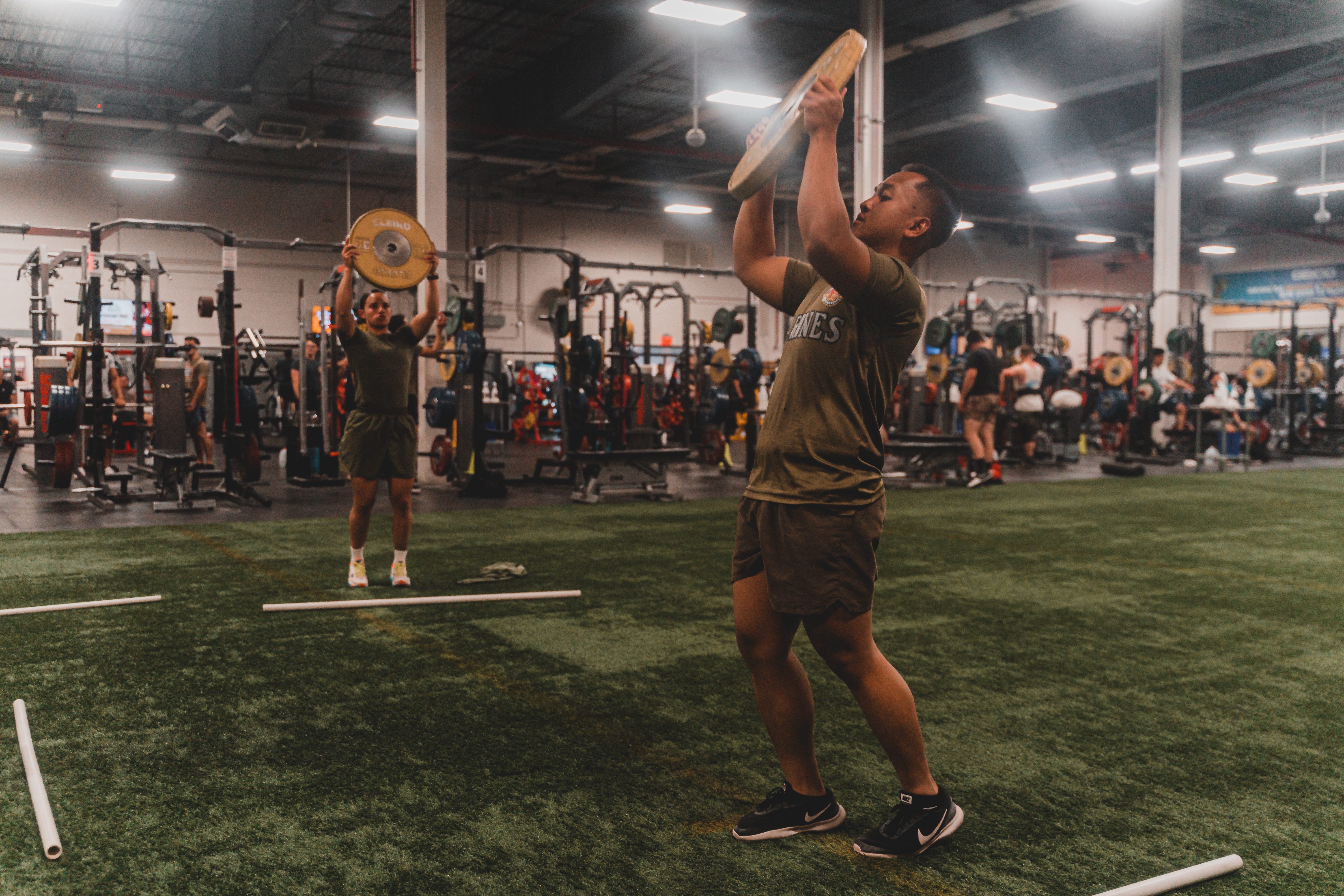 Marines working out at an indoor gym.
