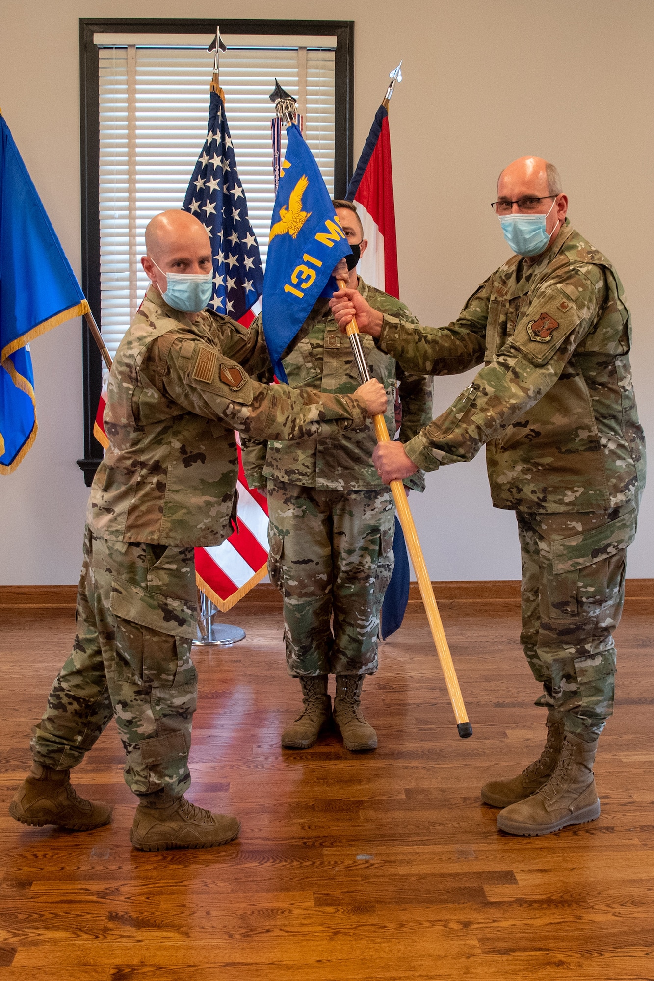 Col. Matthew Calhoun, left, commander of the 131st Bomb Wing, passes the 131st Mission Support Group (MSG) guidon to Col. William Miller at Jefferson Barracks Air National Guard Base, St. Louis, Missouri, Jan 9, 2022. Miller assumed command of the group during January drill. (U.S. Air National Guard photo by Airman 1st Class Whitney Erhart)