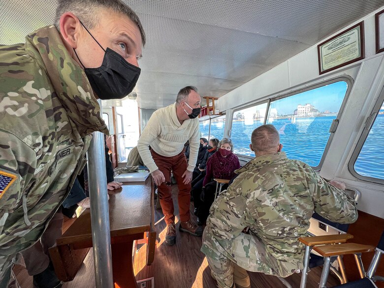 U.S. Army Corps of Engineers, Maryland Port Administration, and Assistant Secretary of the Army for Civil Works leadership examine Chesapeake Bay freight transportation operations in the distance at the Port of Baltimore in Maryland, Jan. 27, 2022. These mission partners visited the port to strategize streamlining logistics and supply chain improvements for the nation’s busiest e-commerce port destination. (U.S. Army photo by Greg Nash)