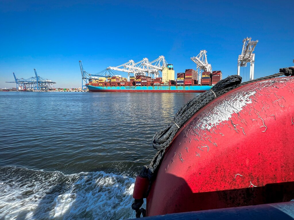 Ongoing Chesapeake Bay freight transportation services occur on a Maersk container ship in the distance at the Port of Baltimore's Dundalk and Seagirt Marine Terminals in Maryland, Jan. 27, 2022.   The port centralizes alongside the tidal basins of the three branches of the Patapsco River in Baltimore, on the upper northwest shore of the Chesapeake Bay. It is the nation's largest port facility for specialized cargo (roll-on/roll-off ships) and passenger facilities. (U.S. Army photo by Greg Nash)