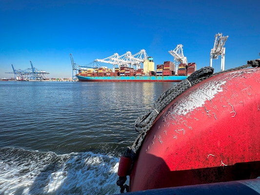 Ongoing Chesapeake Bay freight transportation services occur on a Maersk container ship in the distance at the Port of Baltimore's Dundalk and Seagirt Marine Terminals in Maryland, Jan. 27, 2022.   The port centralizes alongside the tidal basins of the three branches of the Patapsco River in Baltimore, on the upper northwest shore of the Chesapeake Bay. It is the nation's largest port facility for specialized cargo (roll-on/roll-off ships) and passenger facilities. (U.S. Army photo by Greg Nash)