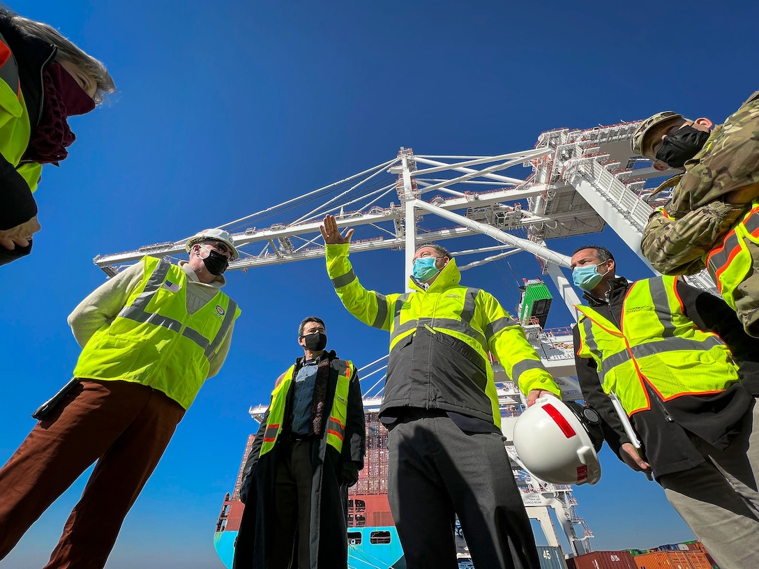 Bayard Hogans, Ports America Chesapeake Vice President, center, briefs mission partners from the U.S. Army Corps of Engineers about the Seagirt and Dundalk terminal's Neo-Panamax crane's operational benefits during a Port of Baltimore tour in Maryland, Jan. 27, 2022. These mission partners strategized how the USACE Baltimore District's Chesapeake Bay protection and restoration efforts help streamline logistics and supply chain improvements for the nation's busiest e-commerce port destination. (U.S. Army photo by Greg Nash)