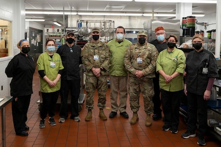 From left, Sgt. Blake Sullivan of Charlie Company, 3rd of the 172nd Infantry (Mountain) Regiment and Staff Sgt. Tom Blythe of Joint Force Headquarters pose for a group photo with the Monadnock Community Hospital’s nutrition and food services department Jan 21, 2022, in Peterborough.
