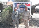 A nephew and uncle pose at a base in Iraq.