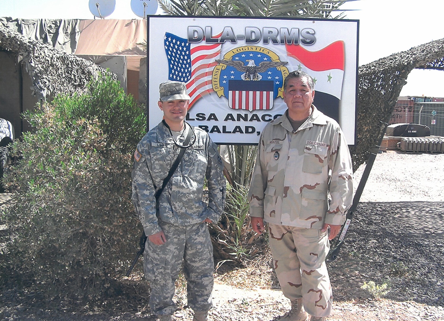 A nephew and uncle pose at a base in Iraq.