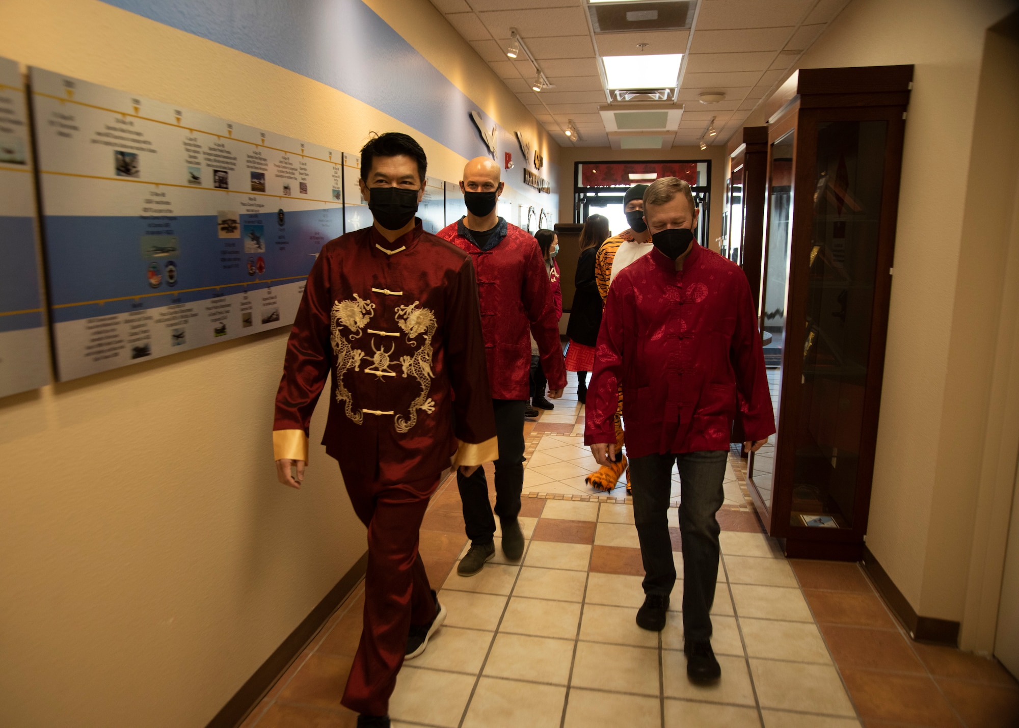 Leadership from the 366th Fighter Wing and 428th Fighter Squadron walk down a hallway.