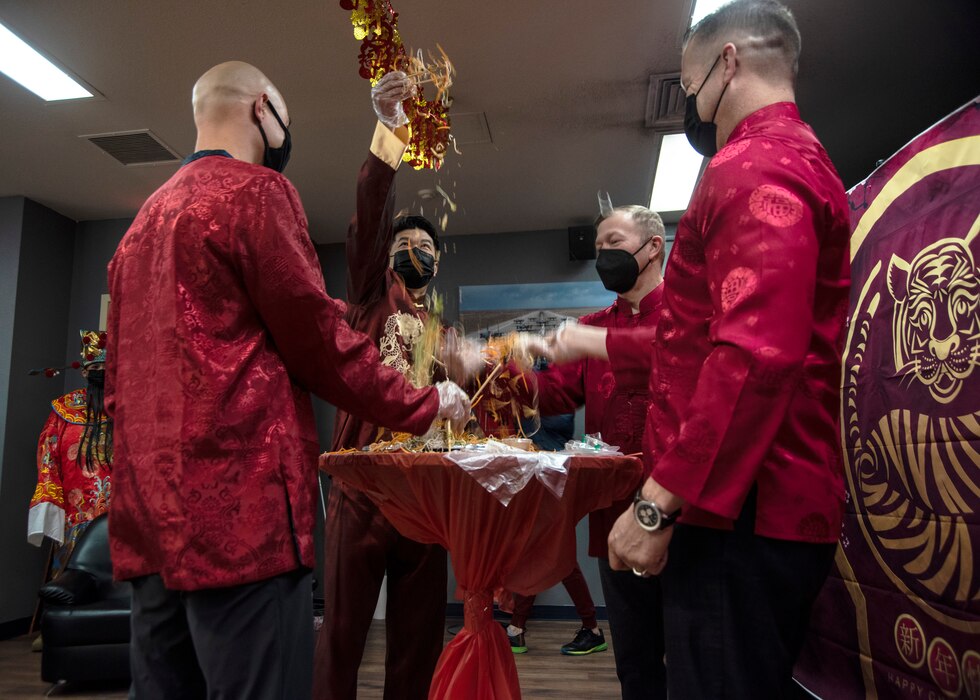 Leadership from the 366th Fighter Wing and 428th Fighter Squadron toss some Lou Hei in the air.