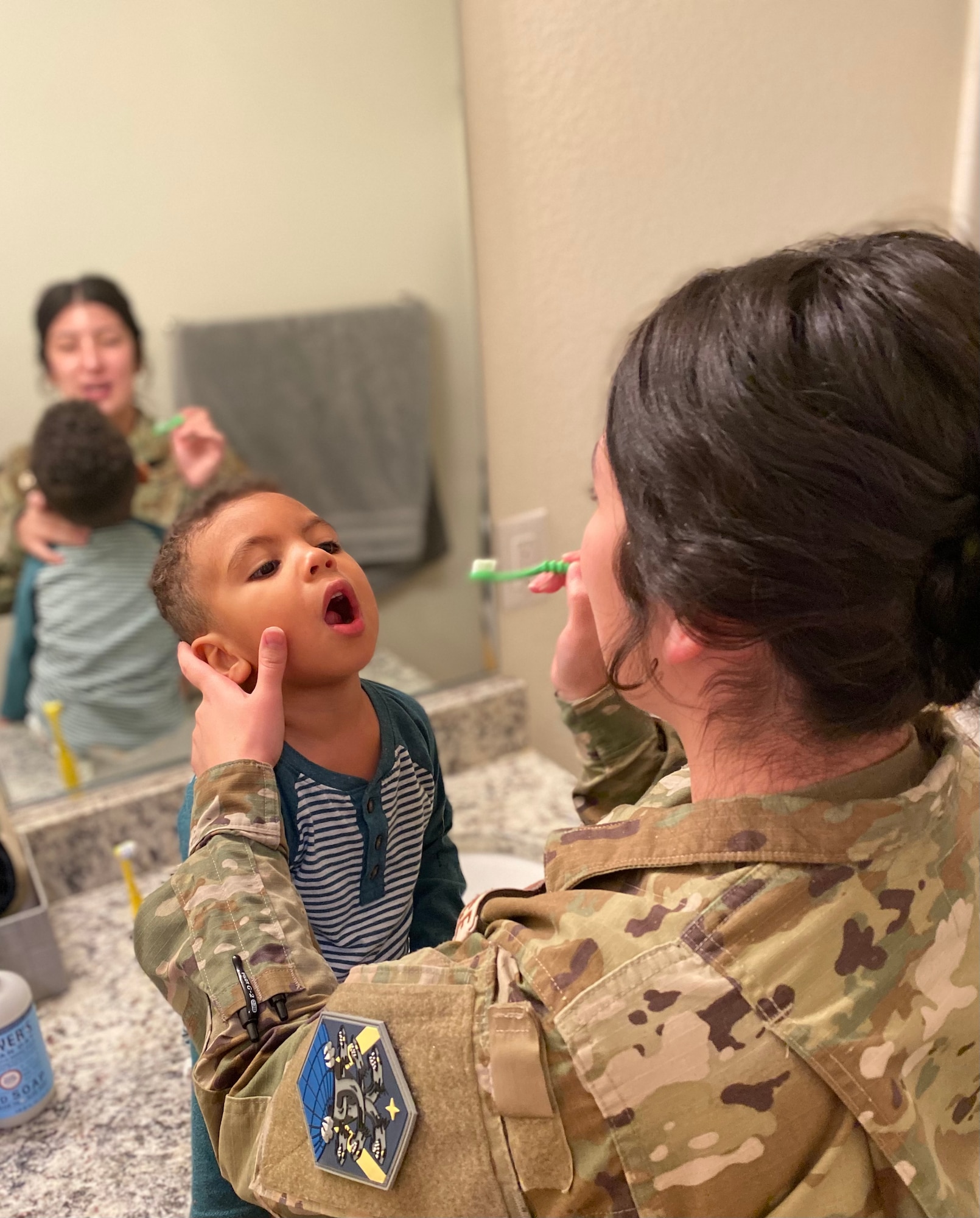 Person brushes child's teeth