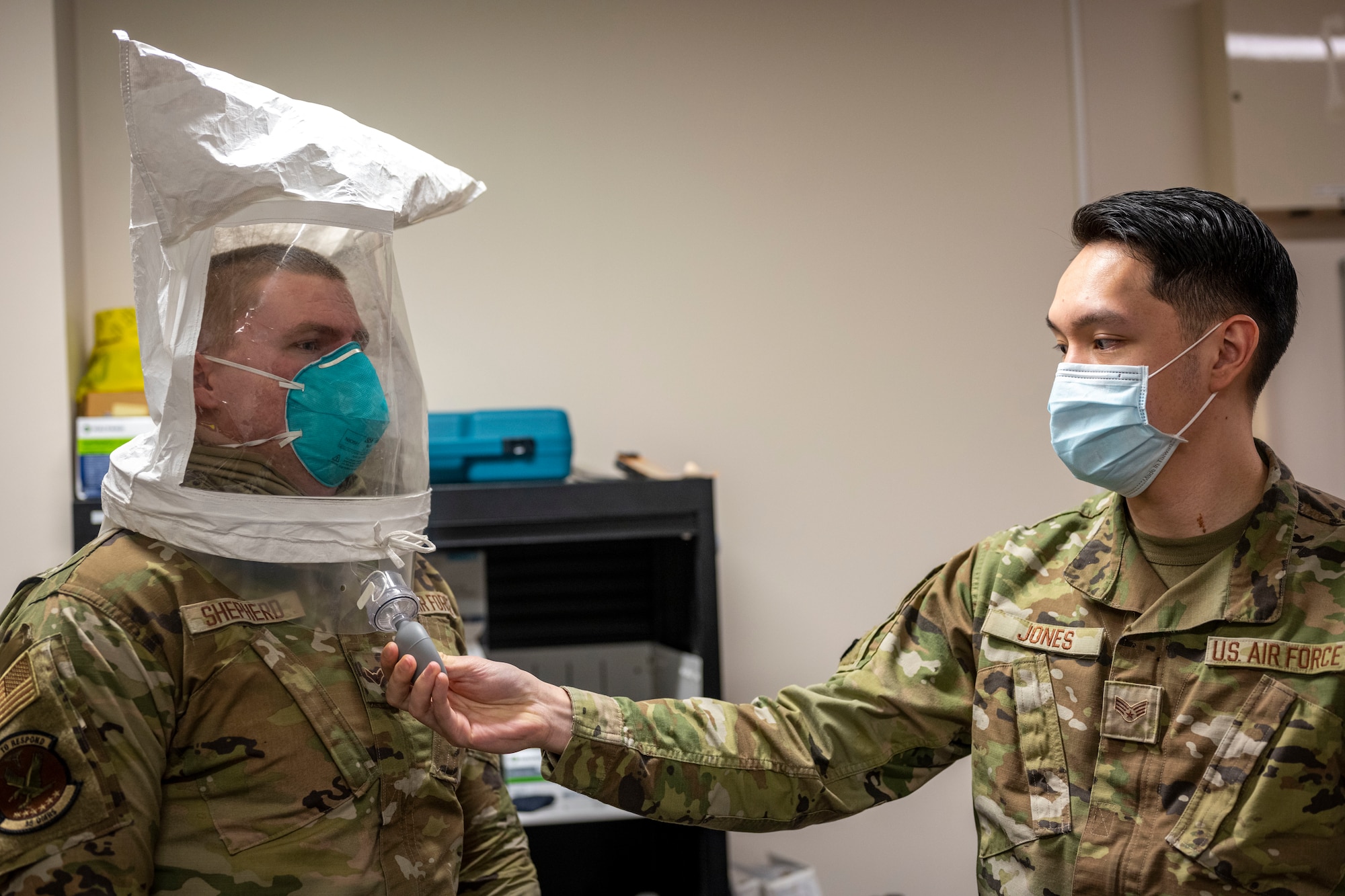 Airman preforming N95 mask fit test.