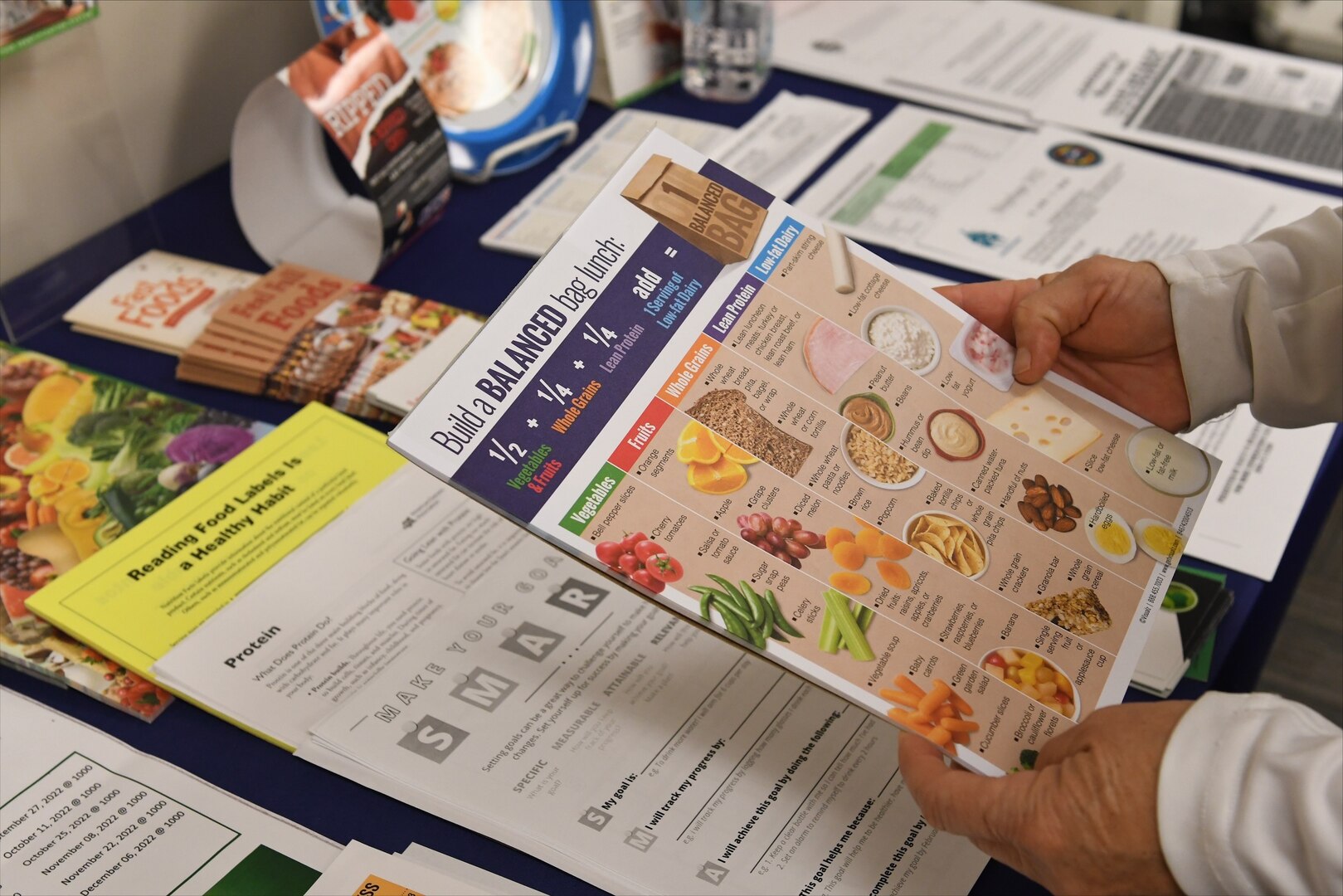 Instructor holding weight management materials.