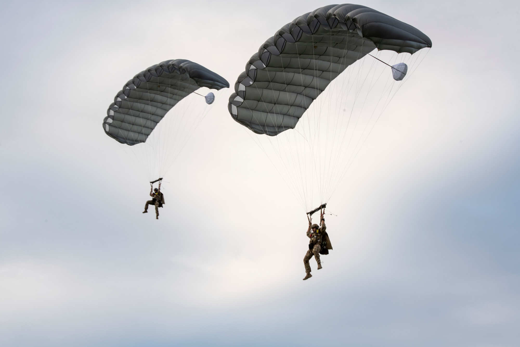 U.S. Air Force Special Forces members fly their parachutes towards the target during joint airborne readiness training on Ie Shima Island