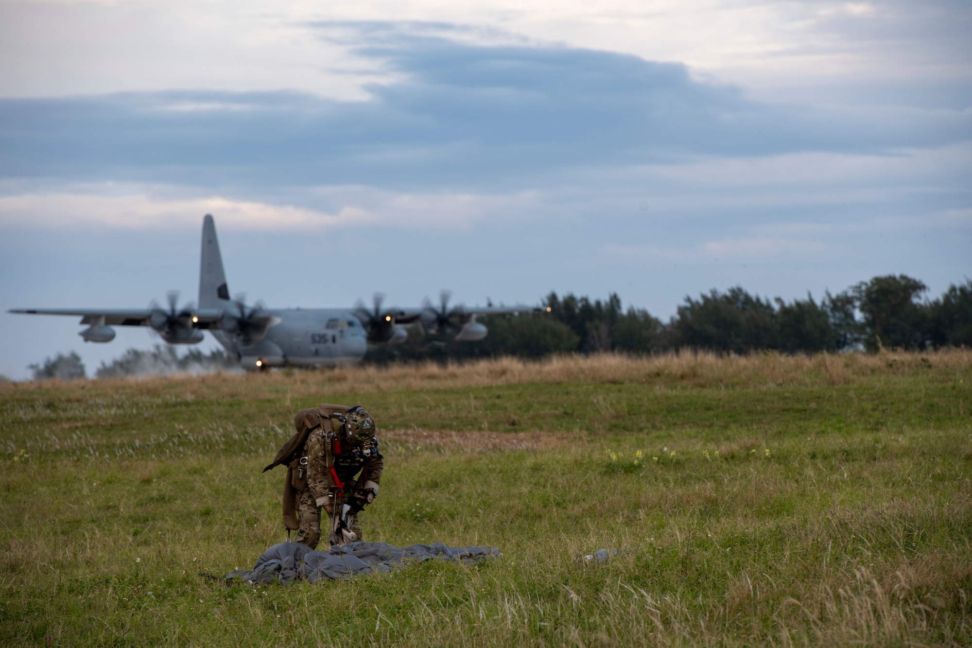 A U.S. Air Force Special Forces member packs up his parachute during joint airborne readiness training on Ie Shima Island