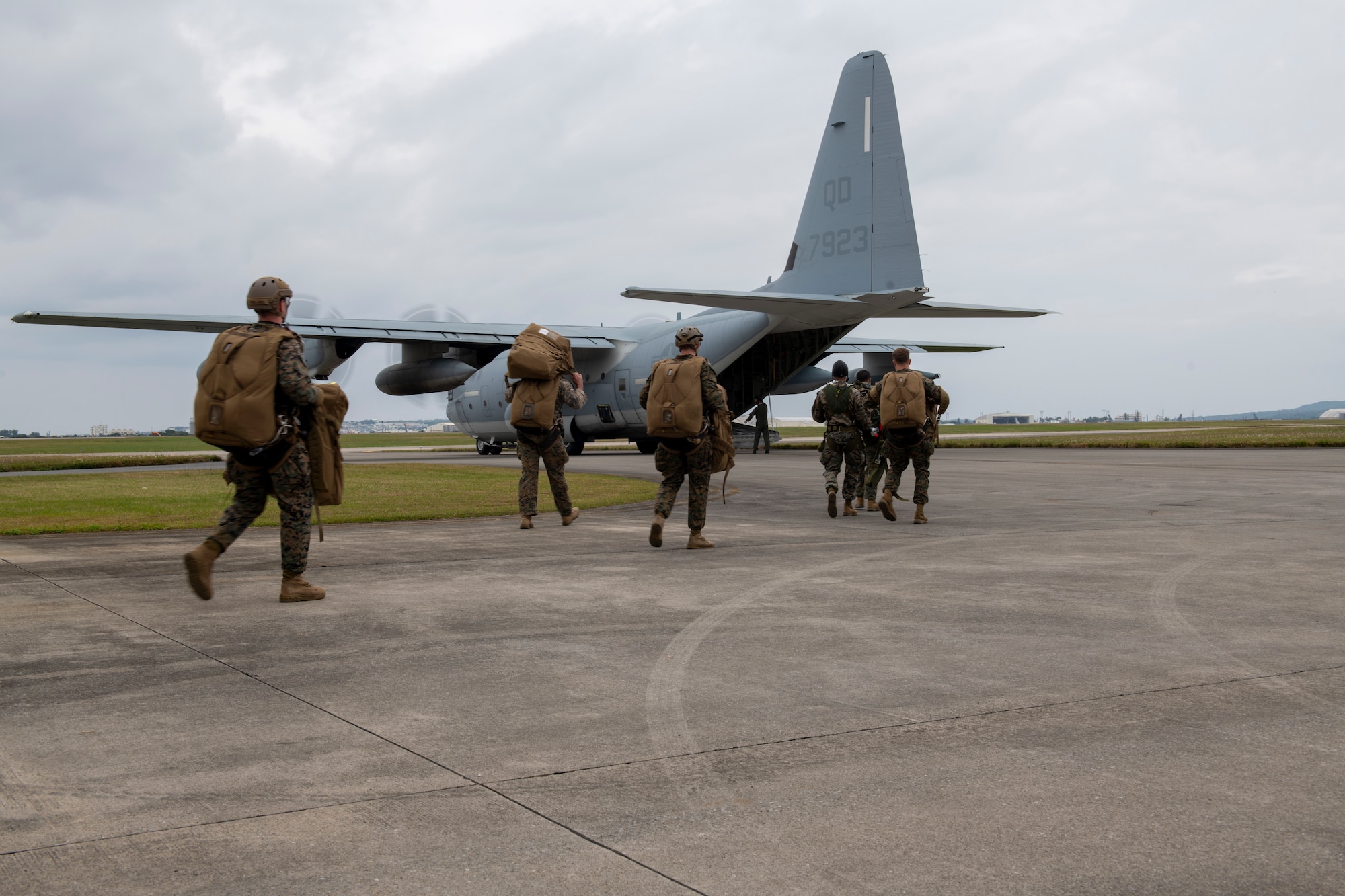 Marines walk towards a KC-130J aircraft