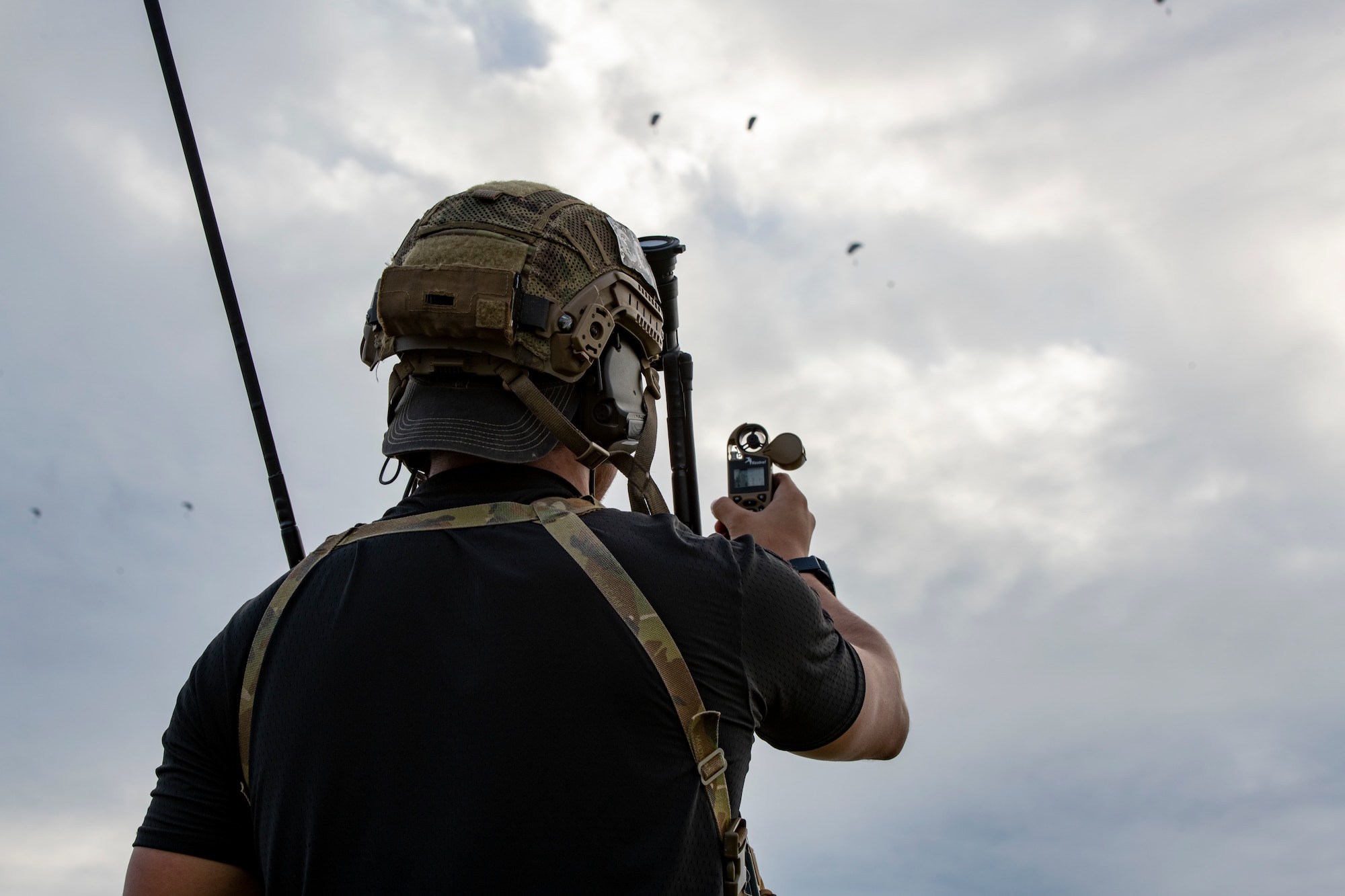 A U.S. Air Force Special Forces member assigned to the 320th Special Tactics Squadron checks weather conditions during joint airborne readiness training on Ie Shima Island