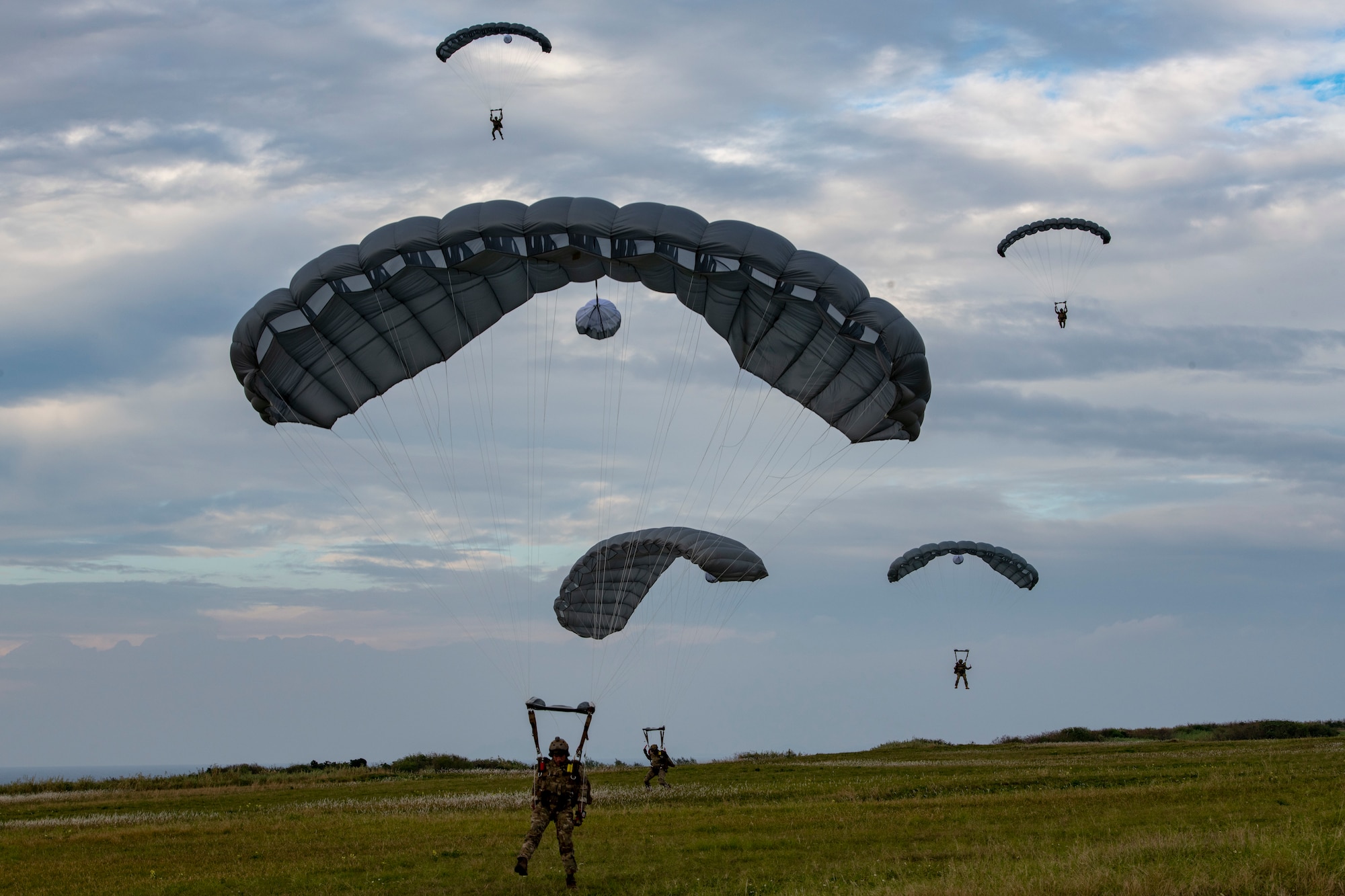 U.S. Air Force Special Forces members land as they execute joint airborne training at Ie Shima, Japan