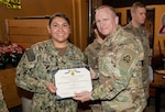 U.S. Army Col. Raymond Jablonka, director U.S. Army North surgeon staff and Joint Force Land Component Command surgeon for COVID-19, presents Lt. Cmdr. Veronica White the Joint Service Achievement Medal for her deployment in support of U.S. North Command  COVID-19 vaccination efforts.