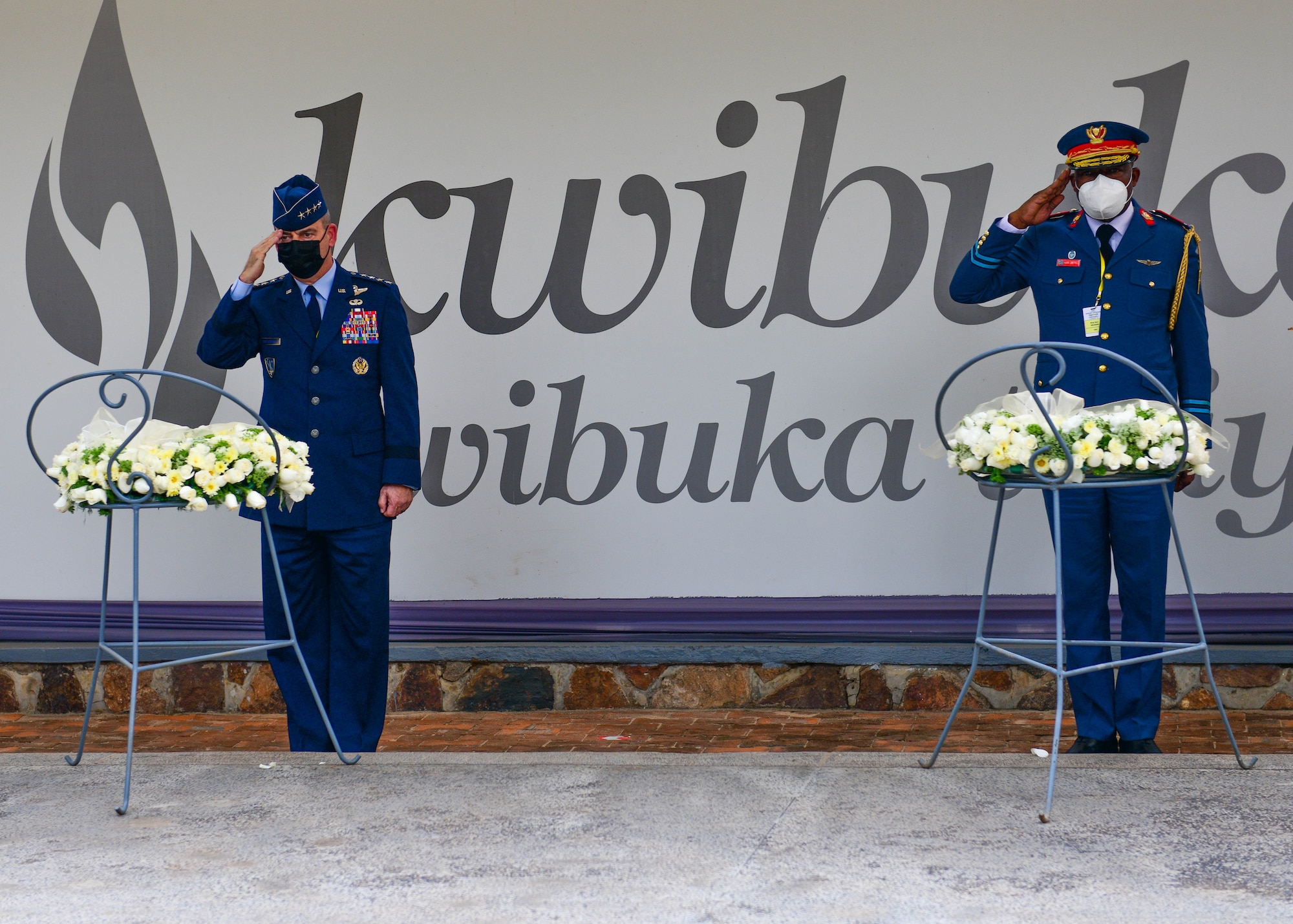 U.S. Air Force Gen. Jeffrey Harrigian, U.S. Air Forces in Europe and Air Forces Africa commander, left, and Armed Forces of the Democratic Republic of the Congo Général de brigade aérienne Franck Lebe Ngama, Deputy Air Chief, Sous-chef d'état-major de l'armée de l'air, salute during a wreath laying ceremony at the Genocide Memorial in Kigali, Rwanda, Jan. 25, 2022. The Genocide Memorial is the final resting place for more than 250,000 victims of the genocide. Harrigian and Ngama are participating in the 2022 African Air Chiefs Symposium, an event that includes a variety of engagement opportunities for participating nations to discuss key challenges confronting African air chiefs. (U.S. Air Force photo by Senior Airman Brooke Moeder)