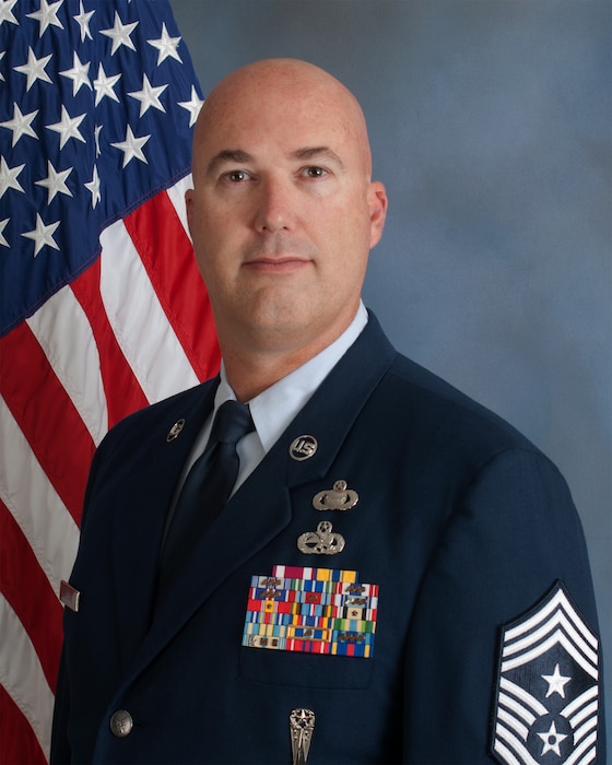 Bio photo of Air Force chief in front of American flag.